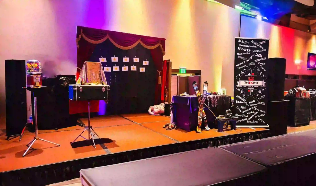Corporate magic show magician Matthew King at Harrah's Rincon Casino with curtains and magic props.