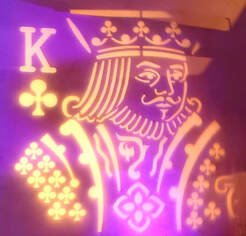 Projection in purple and white of the King of Clubs for San Diego Corporate Magicians Matthew King
