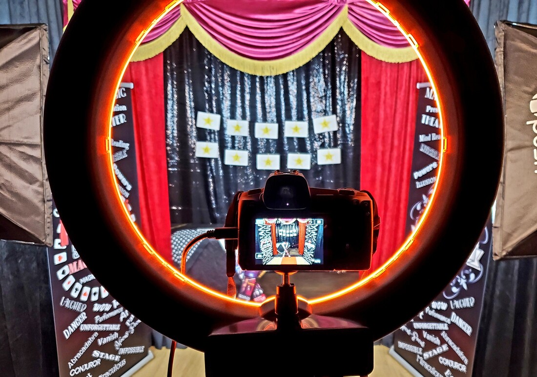 San Diego Magician Matthew King virtual magic show with lights, camera, and red curtains. Mentalist, Comedy magician, and close-up and strolling magician in San Diego.