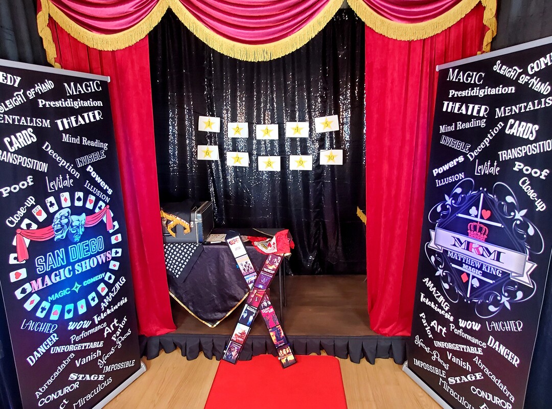 San Diego Magic Show with magician Matthew King red and gold theatre curtains and banners with magic props.