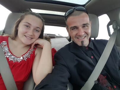 San Diego Magician in Suit with Daughter in Red Dress in Car going to father-daughter dance