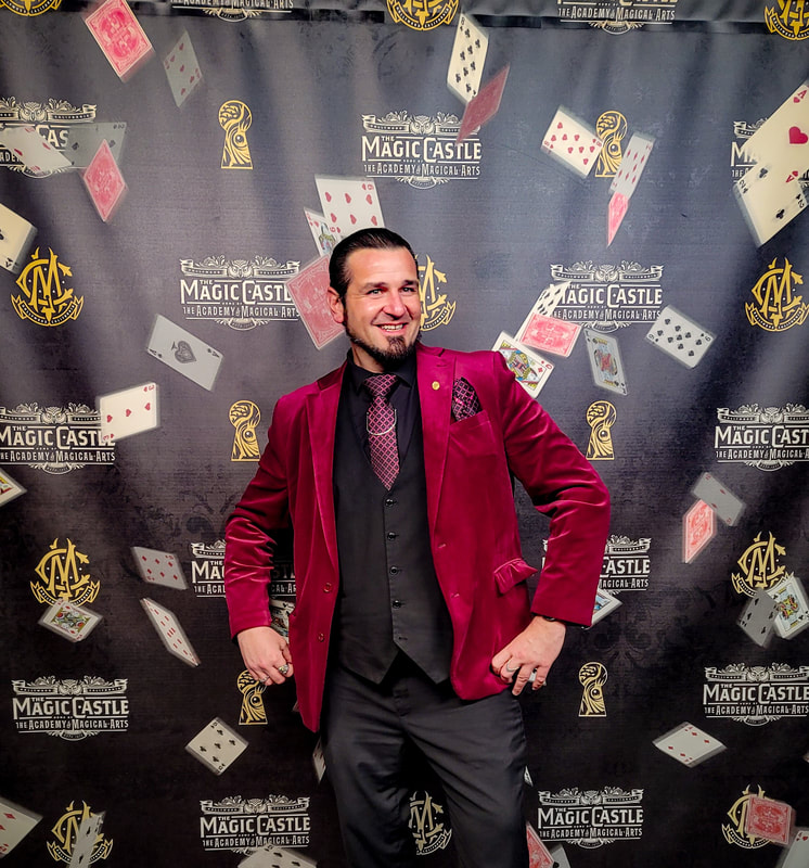 San Diego magician Matthew King in maroon suit outside of The Magic Castle in Hollywood